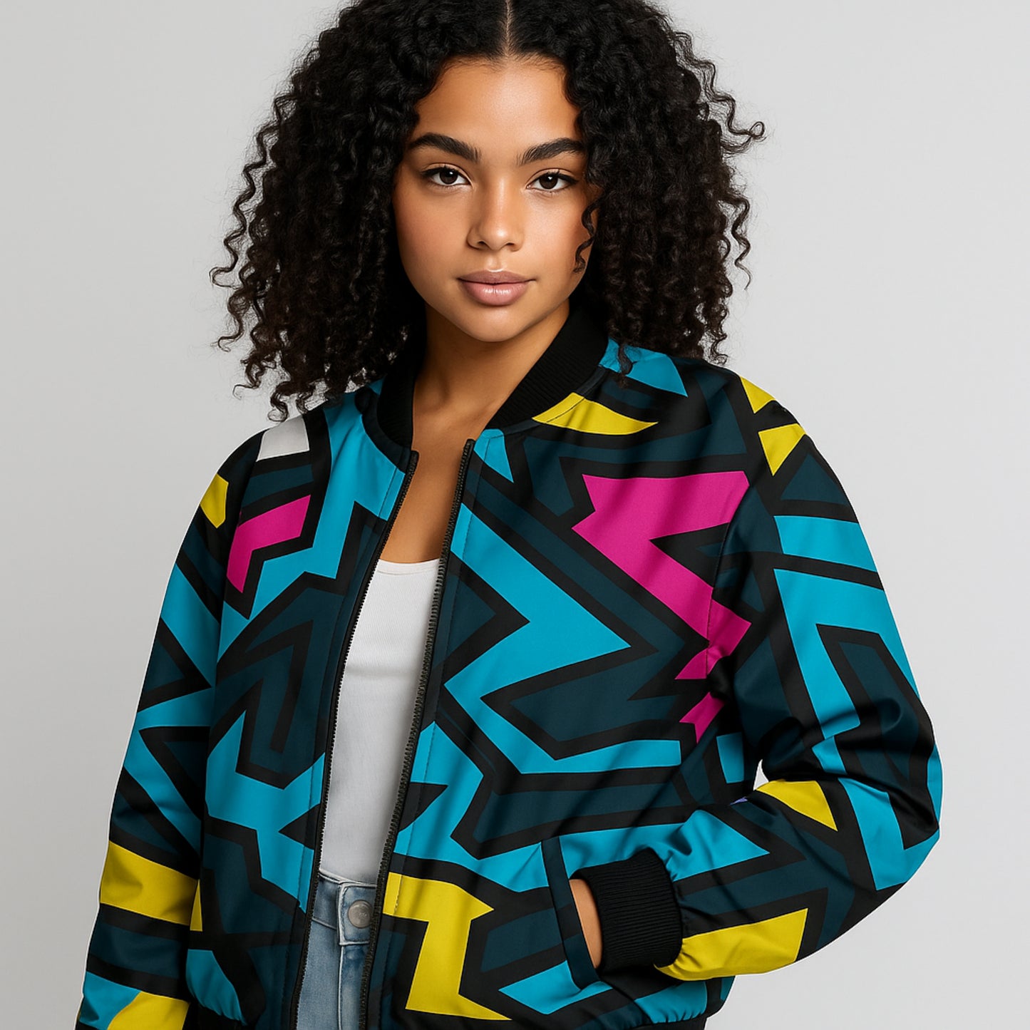 Woman wearing a colorful geometric-patterned jacket on a gray background