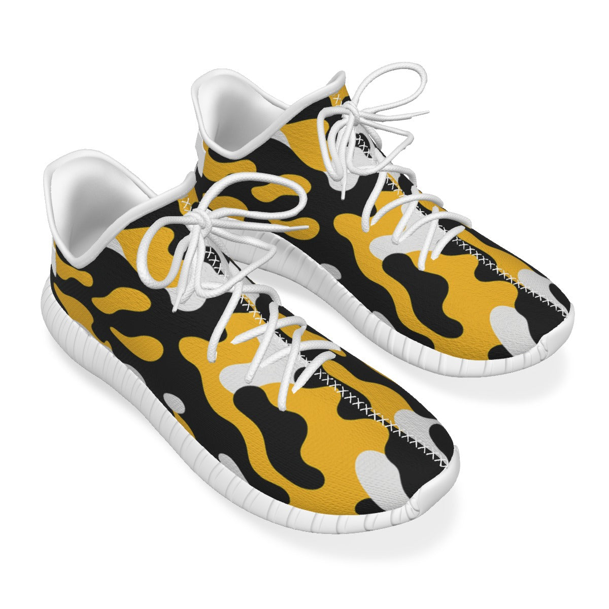 Pair of sneakers with yellow and black camouflage pattern on a white background