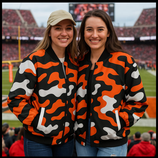 Two women wearing matching camouflage jackets at a sports event.