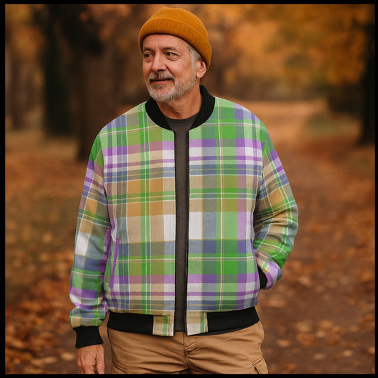 Man wearing a colorful plaid jacket and orange beanie standing in a forest setting