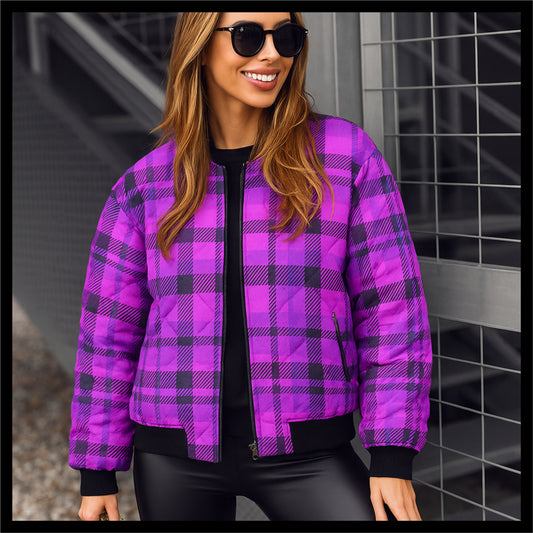 Person wearing a purple and green plaid jacket on a plain background