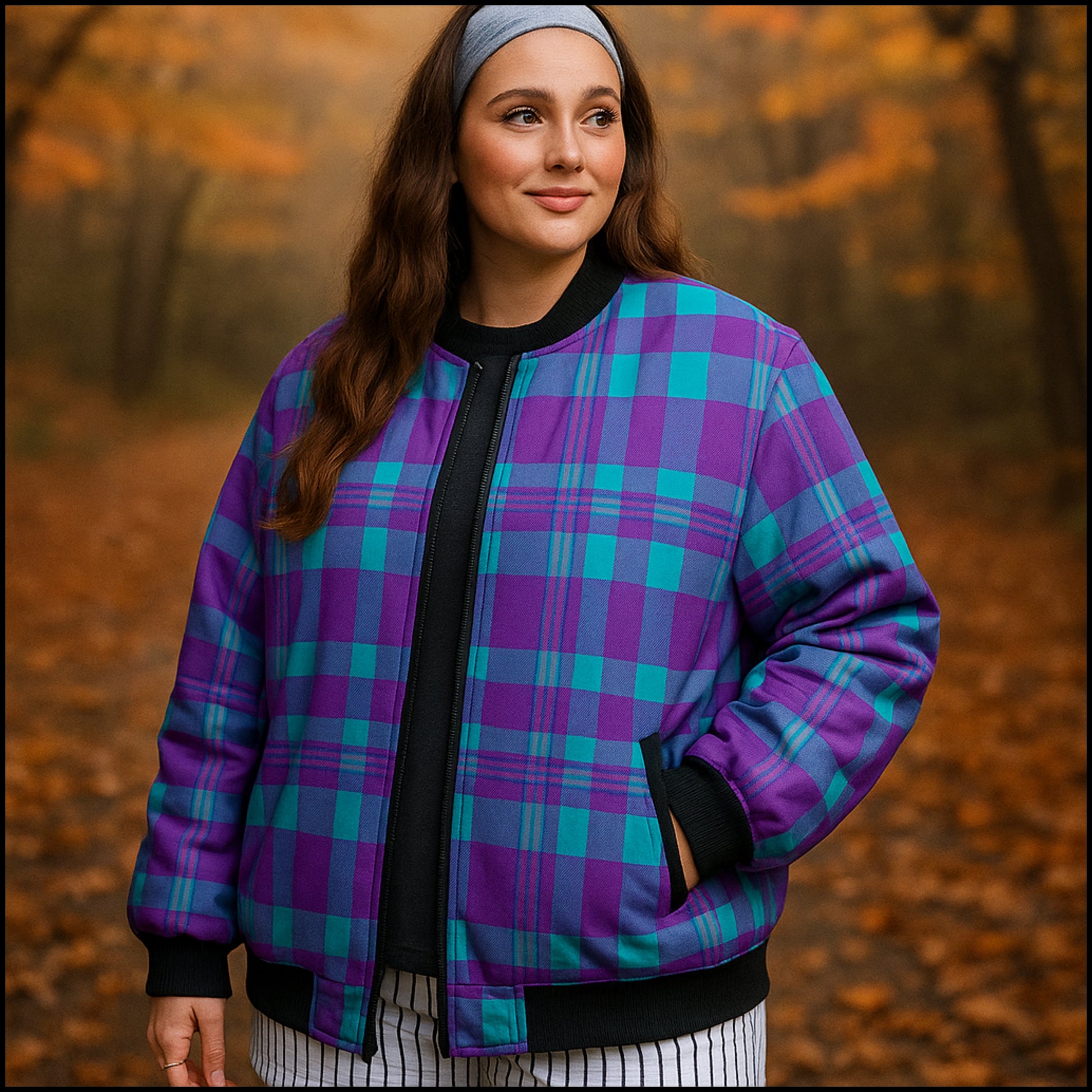 Woman wearing a purple and blue plaid jacket in an autumn forest setting