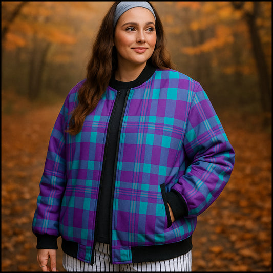 Woman wearing a purple and blue plaid jacket in an autumn forest setting