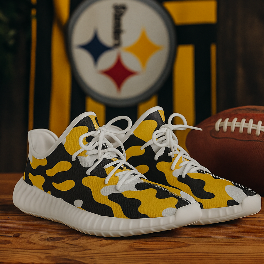 Yellow and black camouflage sneakers with white laces on a wooden surface, with a football and sports team logo in the background.