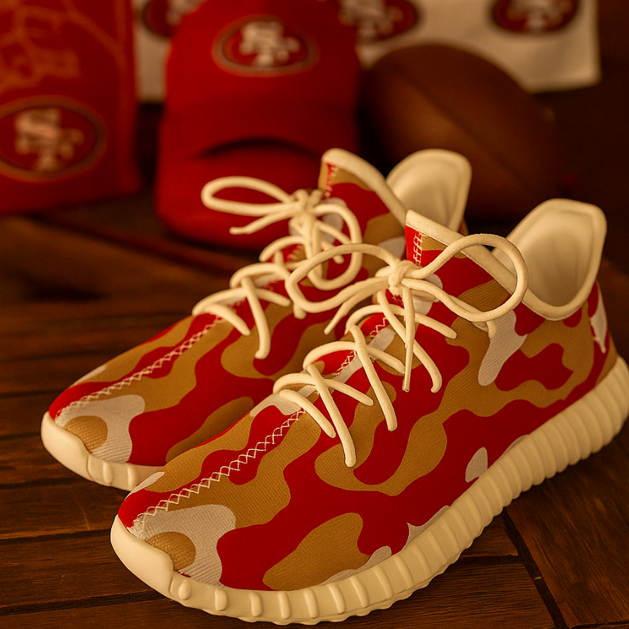 Red and gold camouflage sneakers with white laces on a wooden surface.