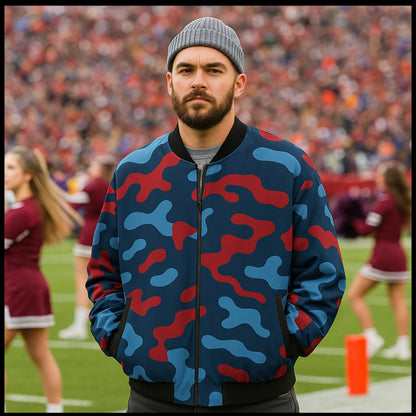 Man wearing a blue and red camouflage jacket on a sports field with blurred background