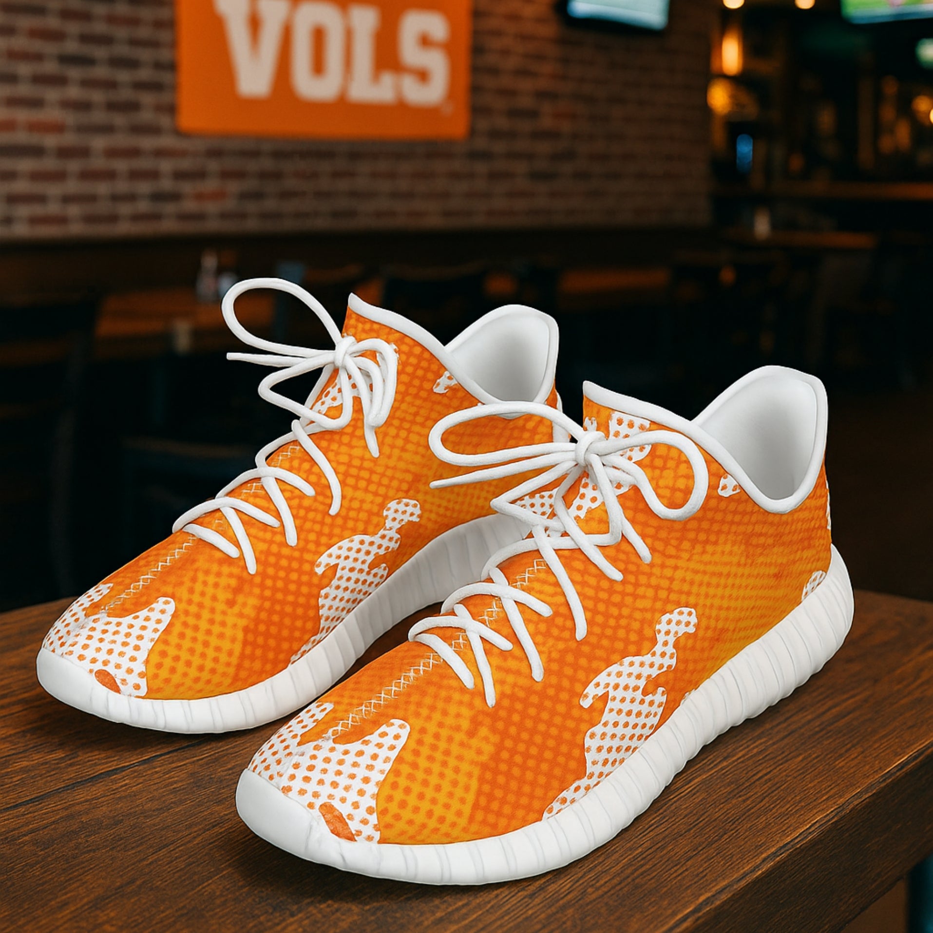 Orange sneakers with white laces on a wooden surface, blurred background