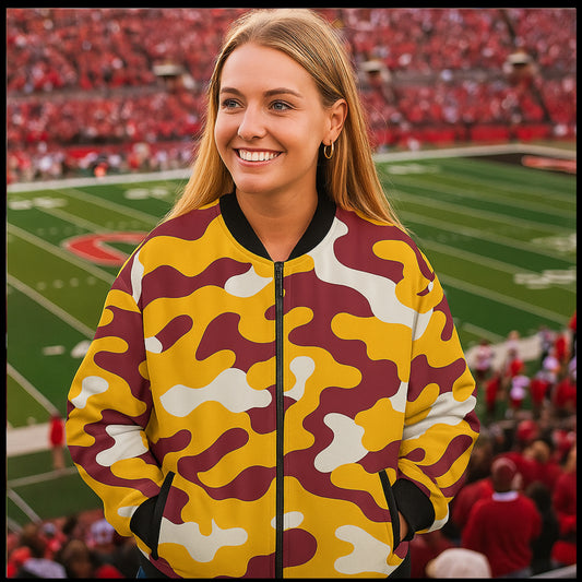 Woman wearing a camouflage jacket on a sports field with spectators in the background